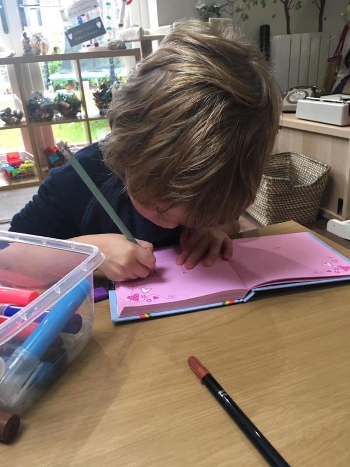 Child writing in a book