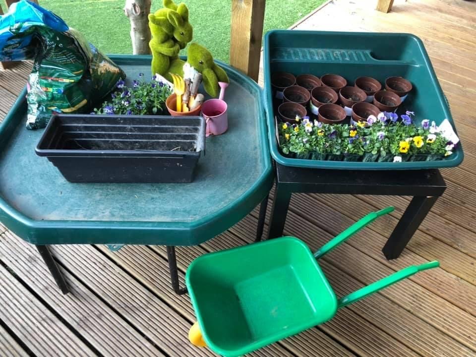 Wheelbarrow, plantpots, flowers and compost