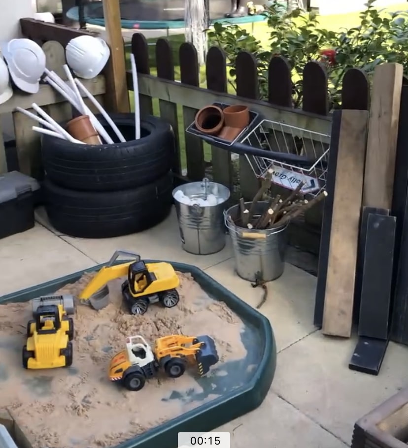 Sandpit containing toy diggers