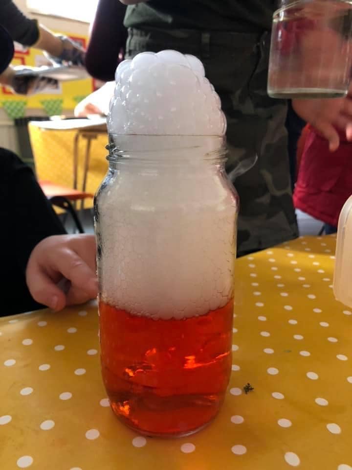 Red liquid with lots of bubbles in a bottle