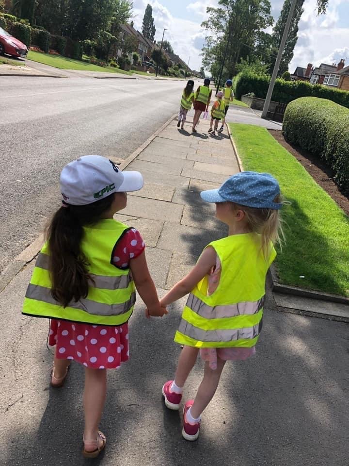 Two children holding hands and looking at each other