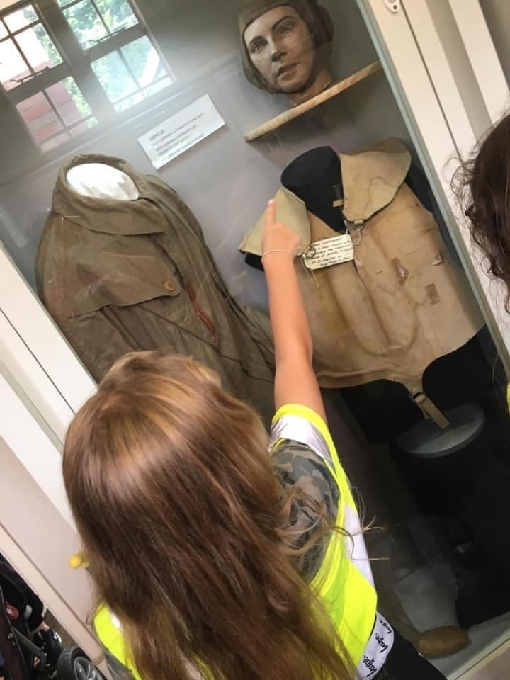 Child pointing at World War 2 memorabilia