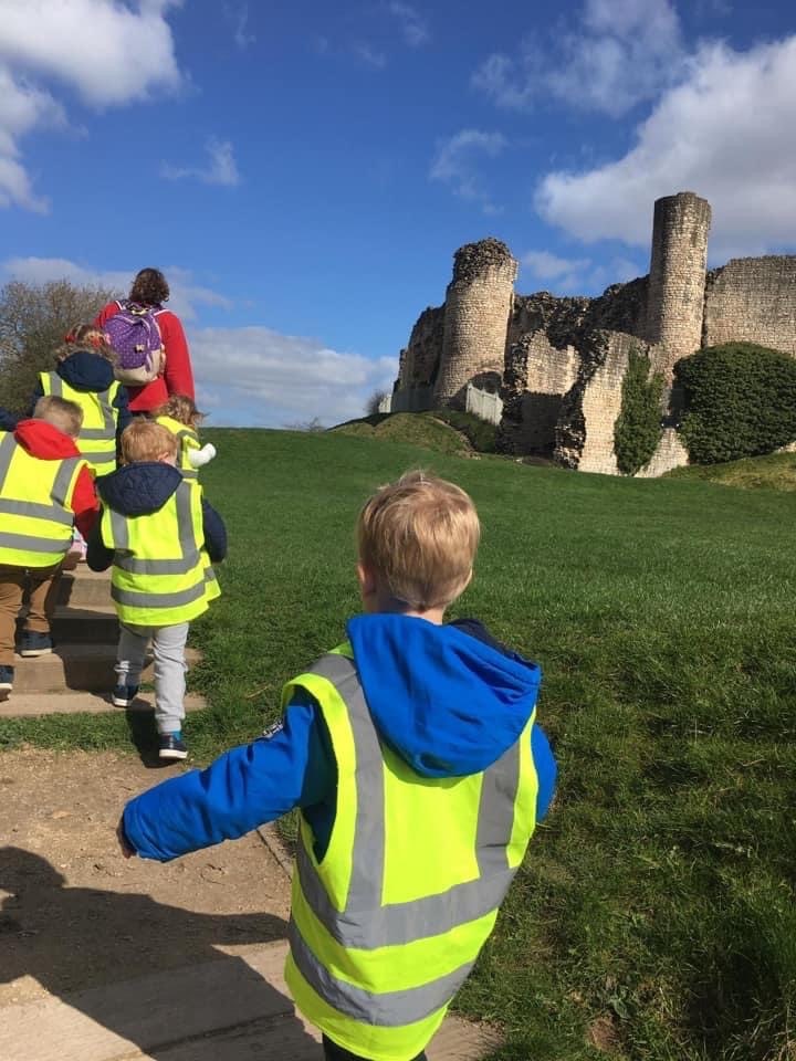 Children walking up a hill to a castle